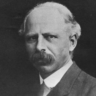 a grayscale photo portrait of leonard hobhouse wearing a suit.