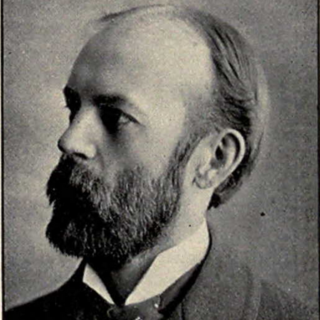 A black-and-white photograph of Charles Cooley. He is wearing an old-fashioned looking suit, he has a full, mid-length beard, and thinning dark hair. He is looking off to the left of the photo. Photo Credit: Unknown photgrapher, 1902, from commons.wikimedia.org