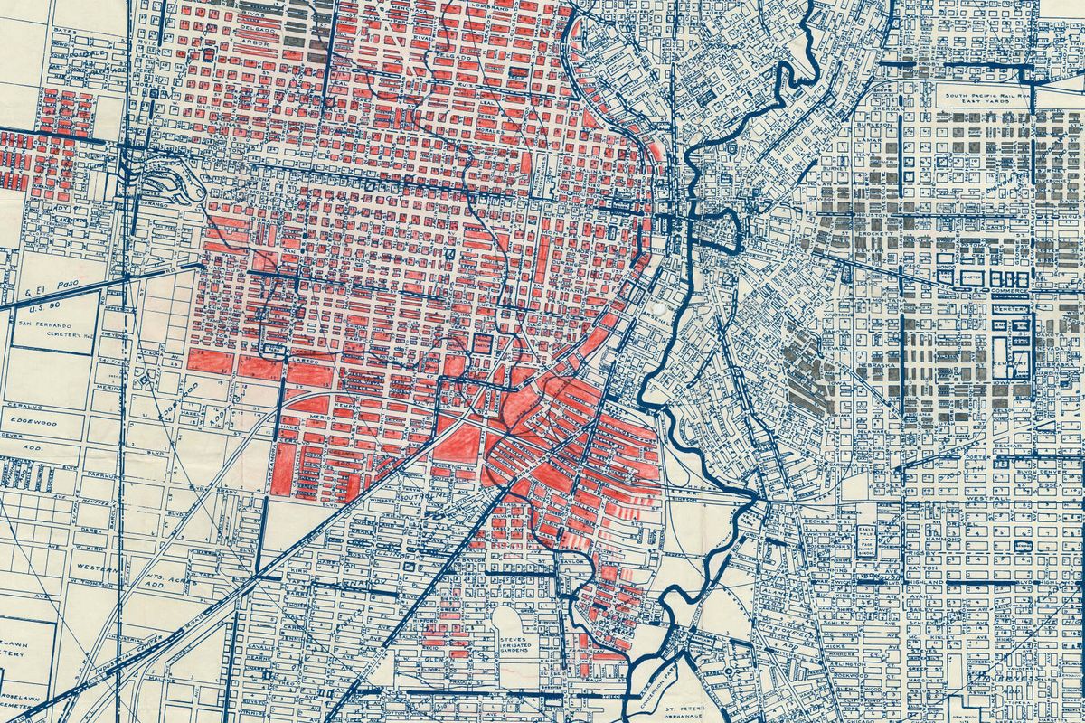A 1930s street map of central San Antonio with neighborhoods shaded solid red to mark areas the survey labeled by race.