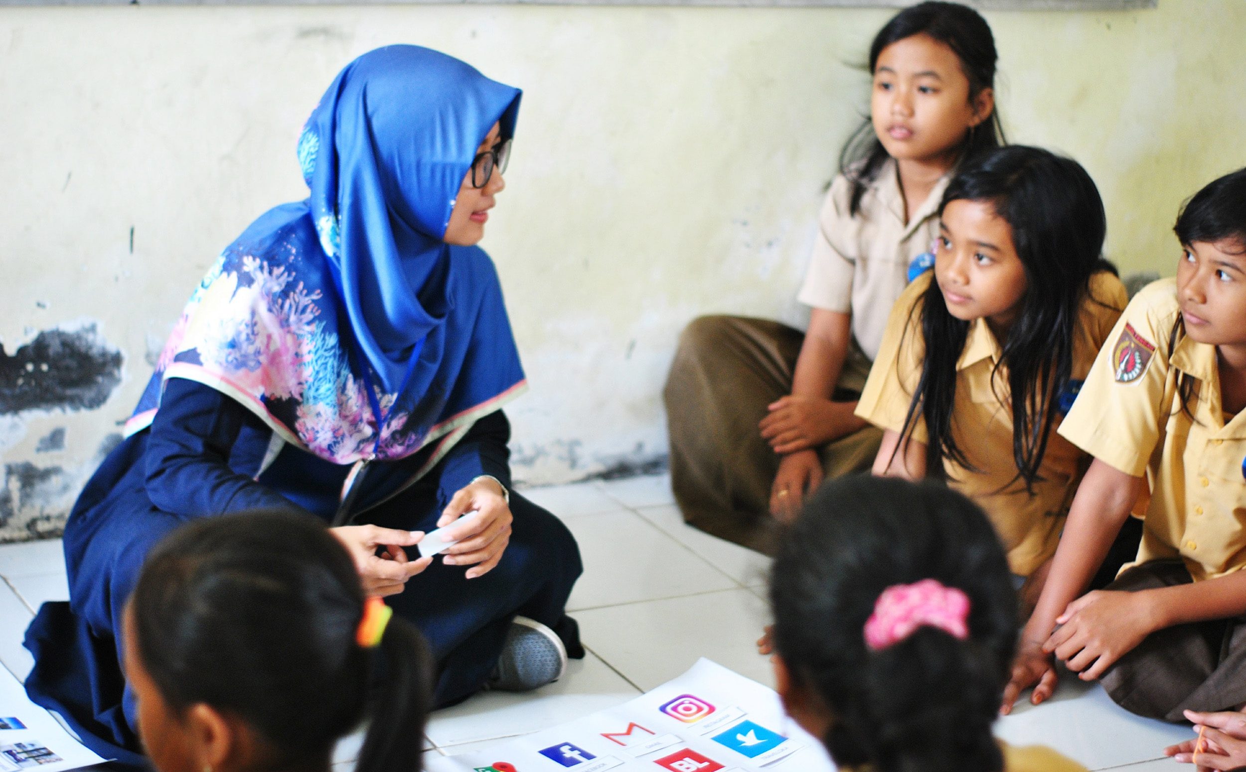 Students in Indonesia gather around their teacher