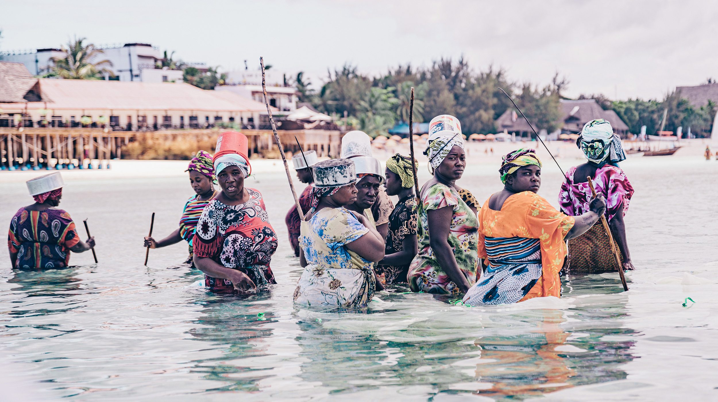 Women in Tanzania cross a body of water