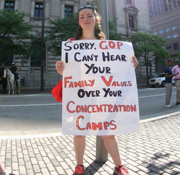 An activist holds a sign protesting the separations of families at the border