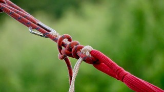 Red and white ropes tied with a strong knot.