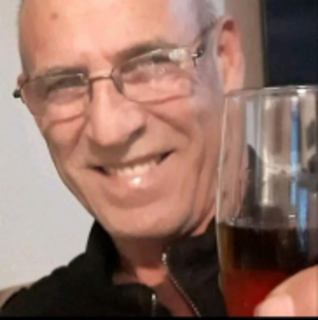 man holding up a glass of wine