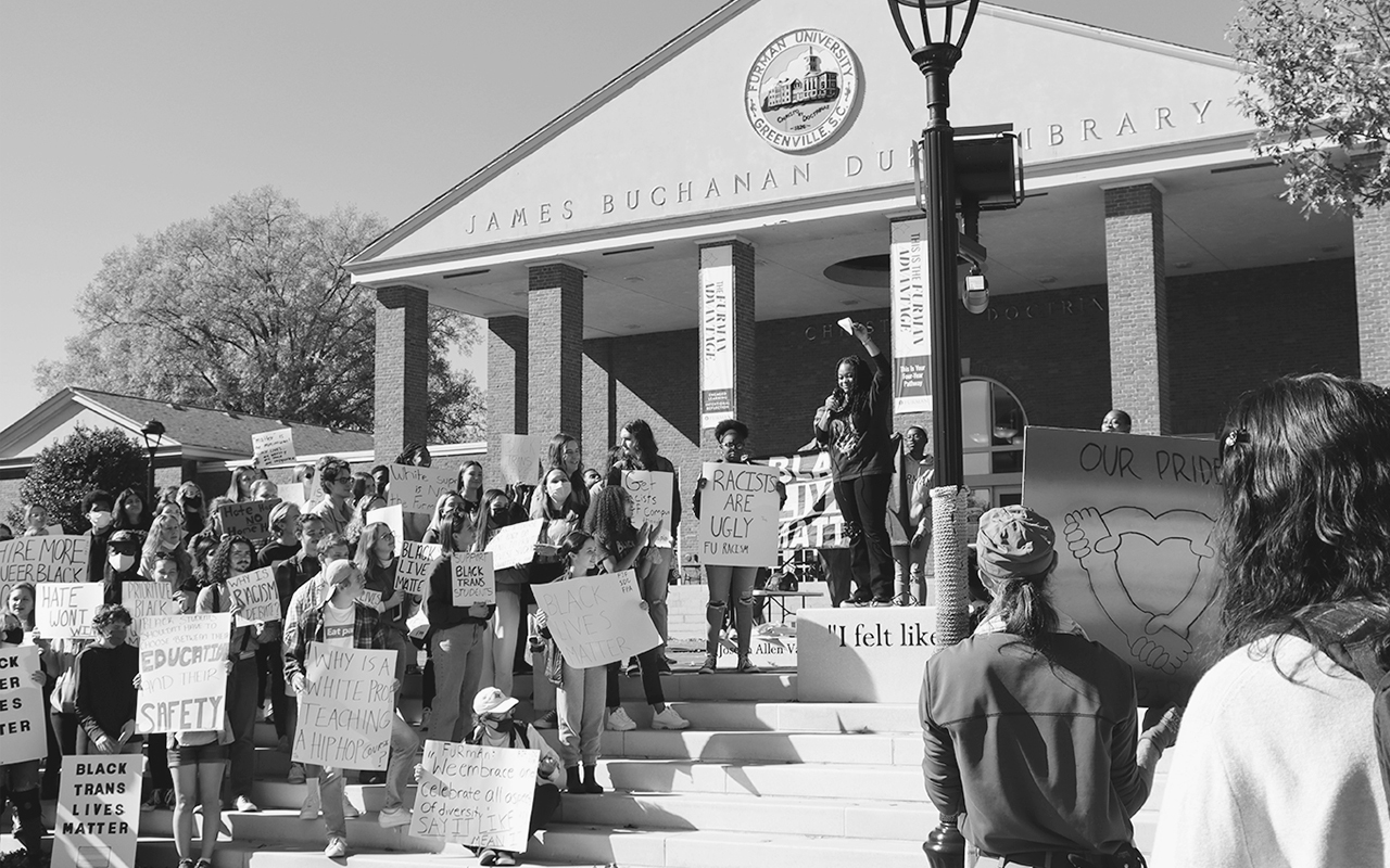 College students hold Black Lives Matter protest signs on library steps