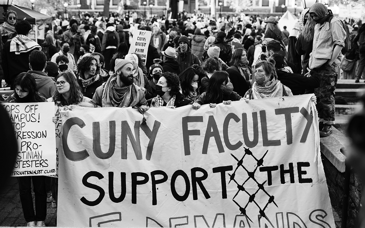 Protesters carrying signs demanding divestment at the City University Campus of New York
