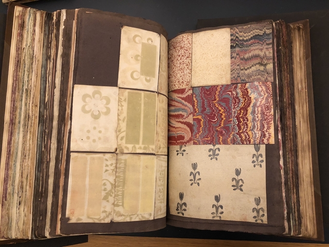 Photograph of marbled papers pasted into a large volume of paper specimens