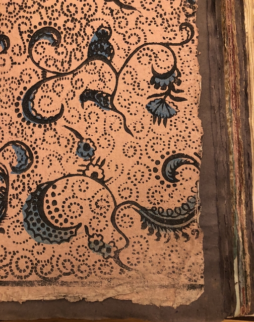 Photograph of a printed paper pasted into a large volume of paper specimens