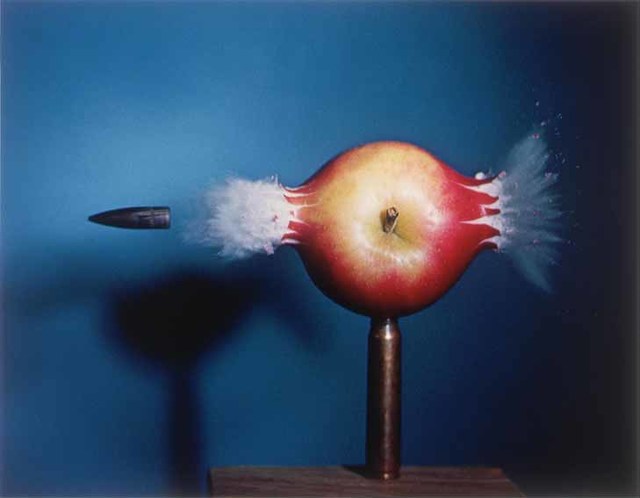 Photograph of a bullet piercing an apple, produced in 1964 by Harold "Doc" Edgerton's with strobe photography