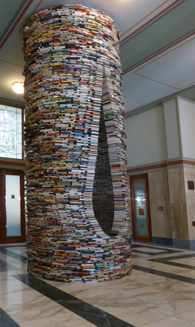 Photograph of a tunneling tower of books made by the artist Matej Kren