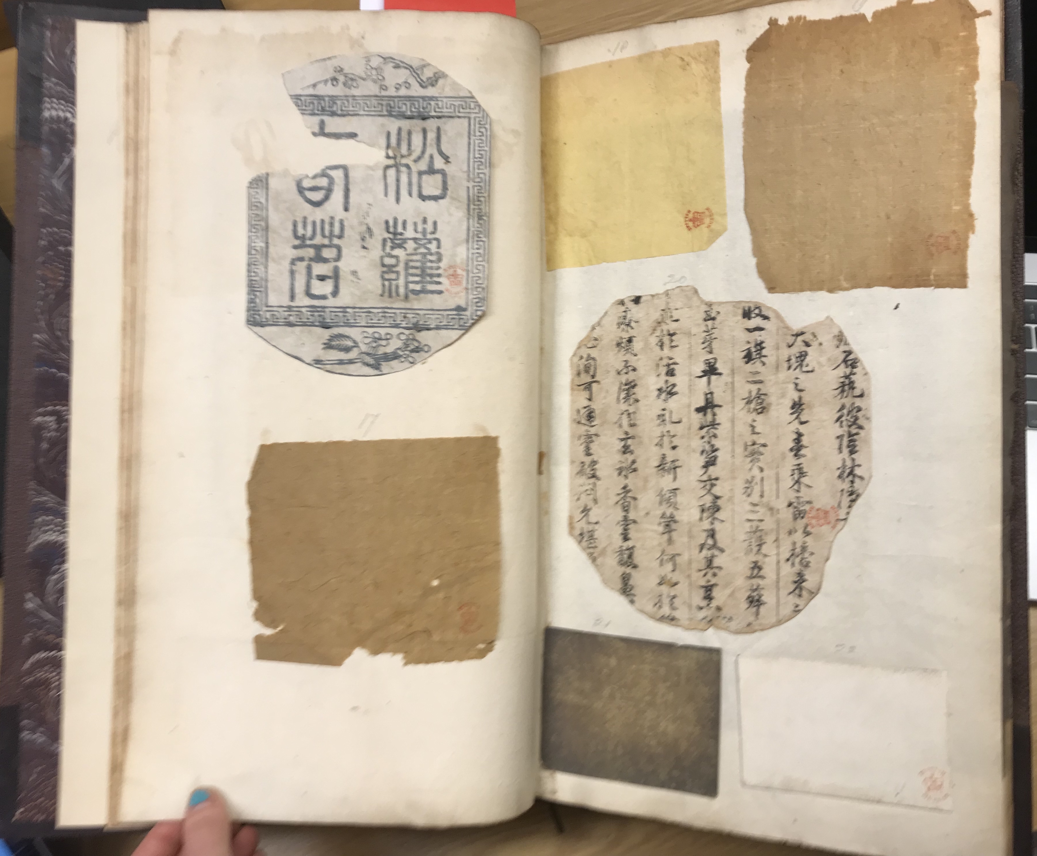 Photograph of a Chinese printing and papers pasted into a manuscript of notes