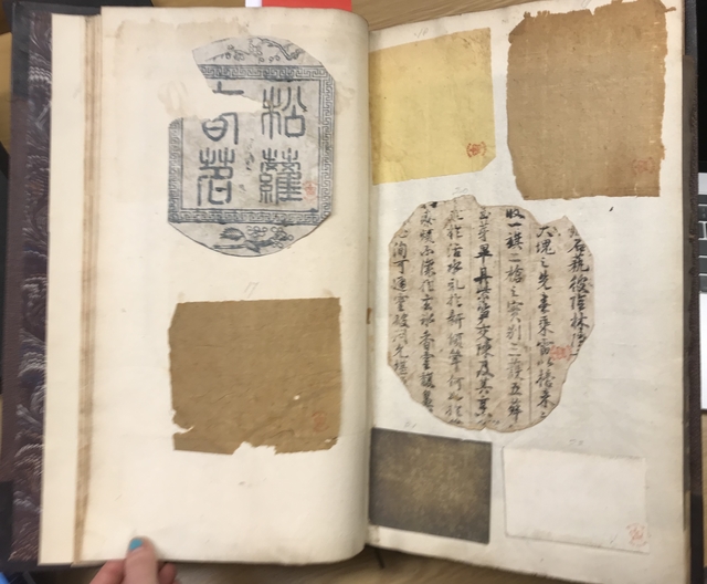 Photograph of a Chinese printing and papers pasted into a manuscript of notes