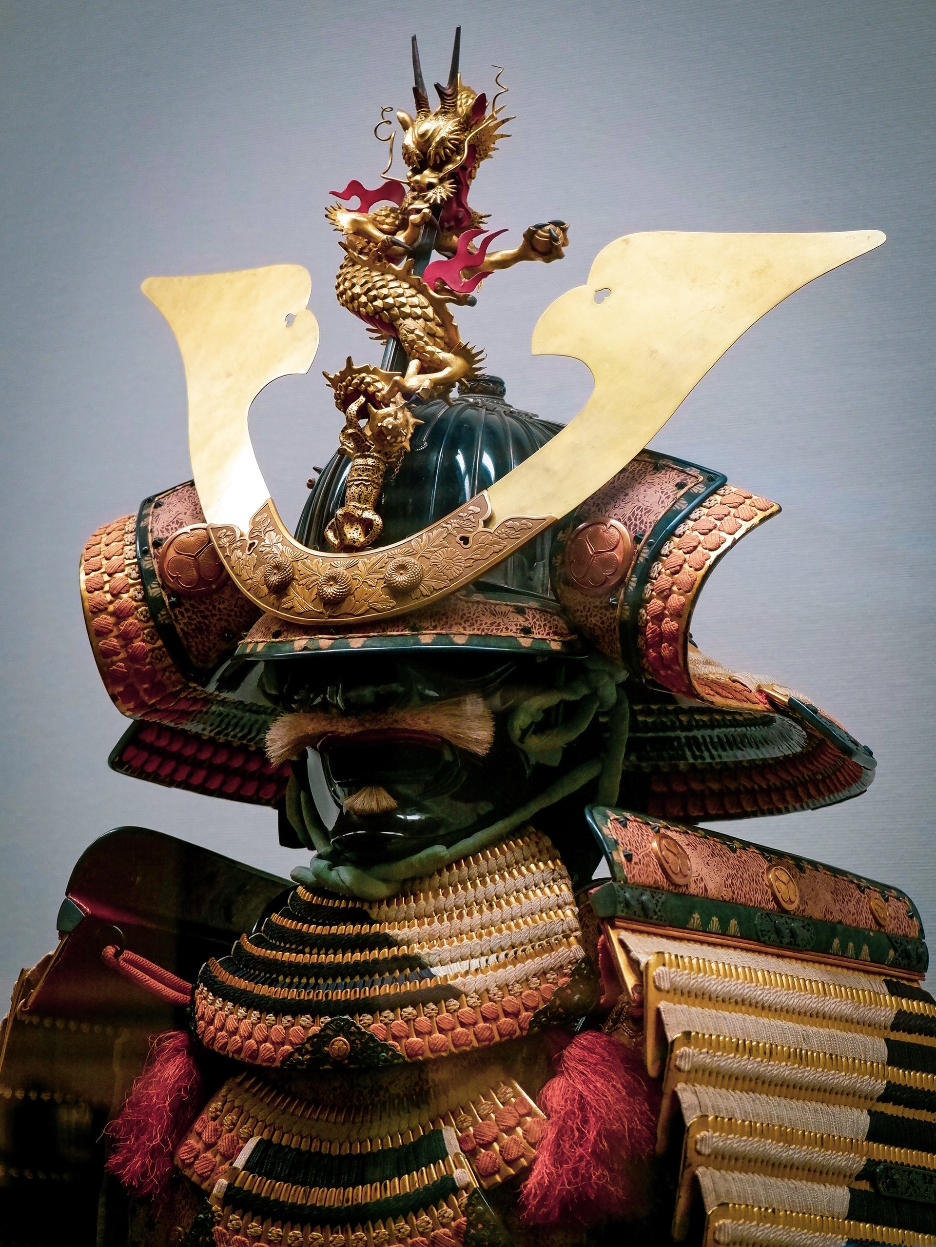 Photo of gold, green, and red Samurai armor