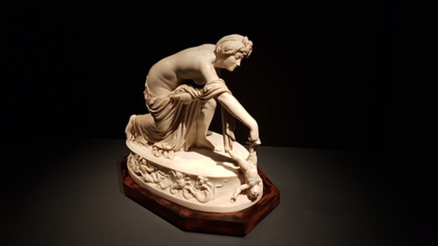 Thetis(Achilles mother) dipping him into the river Styx making him invulnerable, except for his heel which was the only part of Achilles body not dipped into the river. (Thomas Banks,1789 in England). Made with White Sicilian marble on wooden plinth