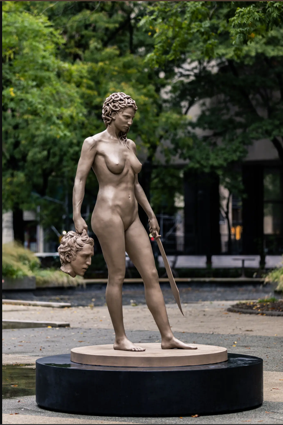 An image of a bronze statue Medusa holding the head of Perseus in one hand and a sword in the other is displayed.