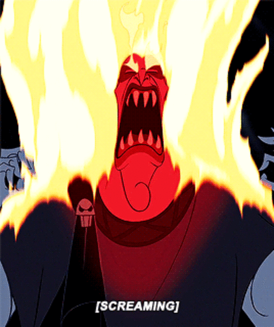 Gif of Hades from Disney's 1997 animated film Hercules yelling in anger. His normal blue flaming hair has turned a bright, fiery orange and yellow, completely engulfing the top of the frame. His pale blue skin is flushed red with rage. His mouth is opening wide in a yell, revealing rows of sharp white teeth. He is wearing dark robes. The text [SCREAMING] is displayed at the bottom of the image.