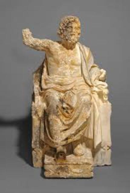 Marble statue of Zeus seated on a throne holding a scepter in his left hand and a thunderbolt in his right wearing a robe and crown of laurel leaves 