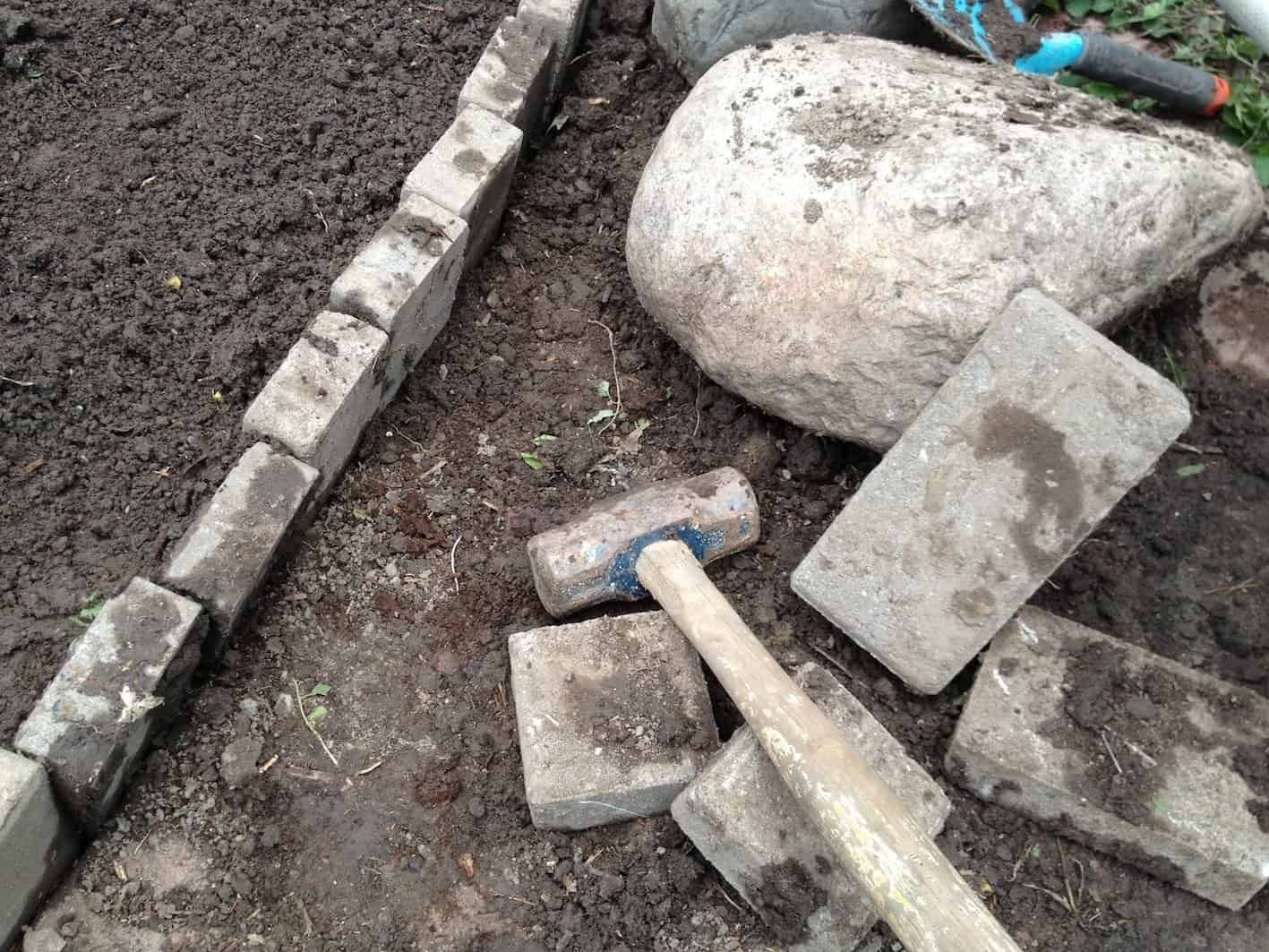 A narrow, shallow trench was dug before pounding the bricks into place. My section wasn’t dead straight, but Boni can adjust the bricks if they look too crooked.