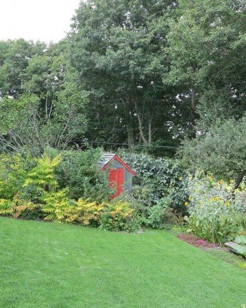 No need to hide or camouflage outbuildings if they’re painted in complementary hues that blend with the surrounding landscape. This practical storage area serves as a focal point in Margaret Roach’s garden in Copake Falls, N.Y. (Garden Making photo).