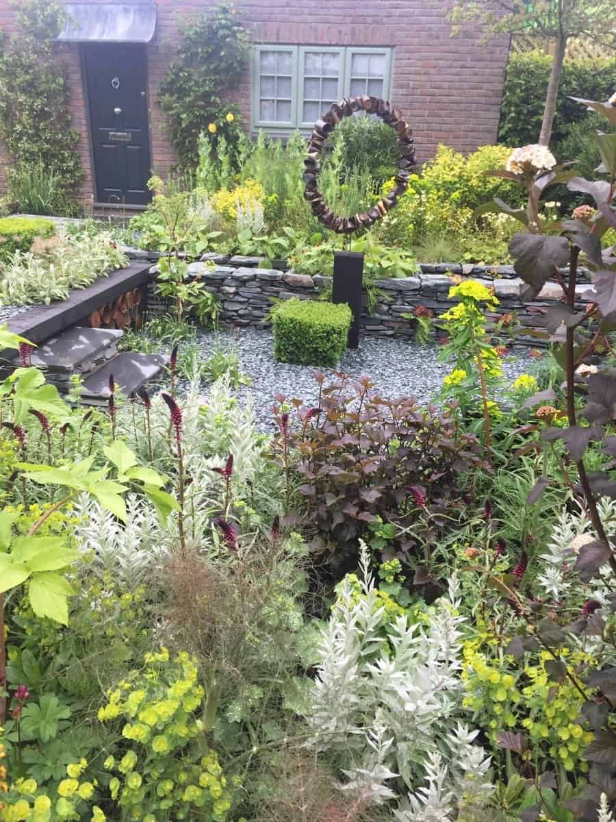 Designed for a recently retired couple, this garden featured sunken areas filled with gold, maroon and silver plants. The sculpture comprised crushed, rusty tin cans (looks better in person.) Obviously, this imaginary couple has more discretionary time than most.