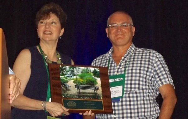 Sean James receiving a landscape design award from Jennifer Brennan, president of the Perennial Plant Association, who is with Chalet Nursery in Chicago.