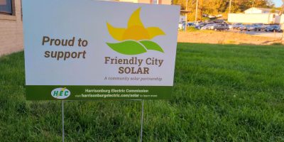 A picture of a yard sign advertising the Friendly City Solar program