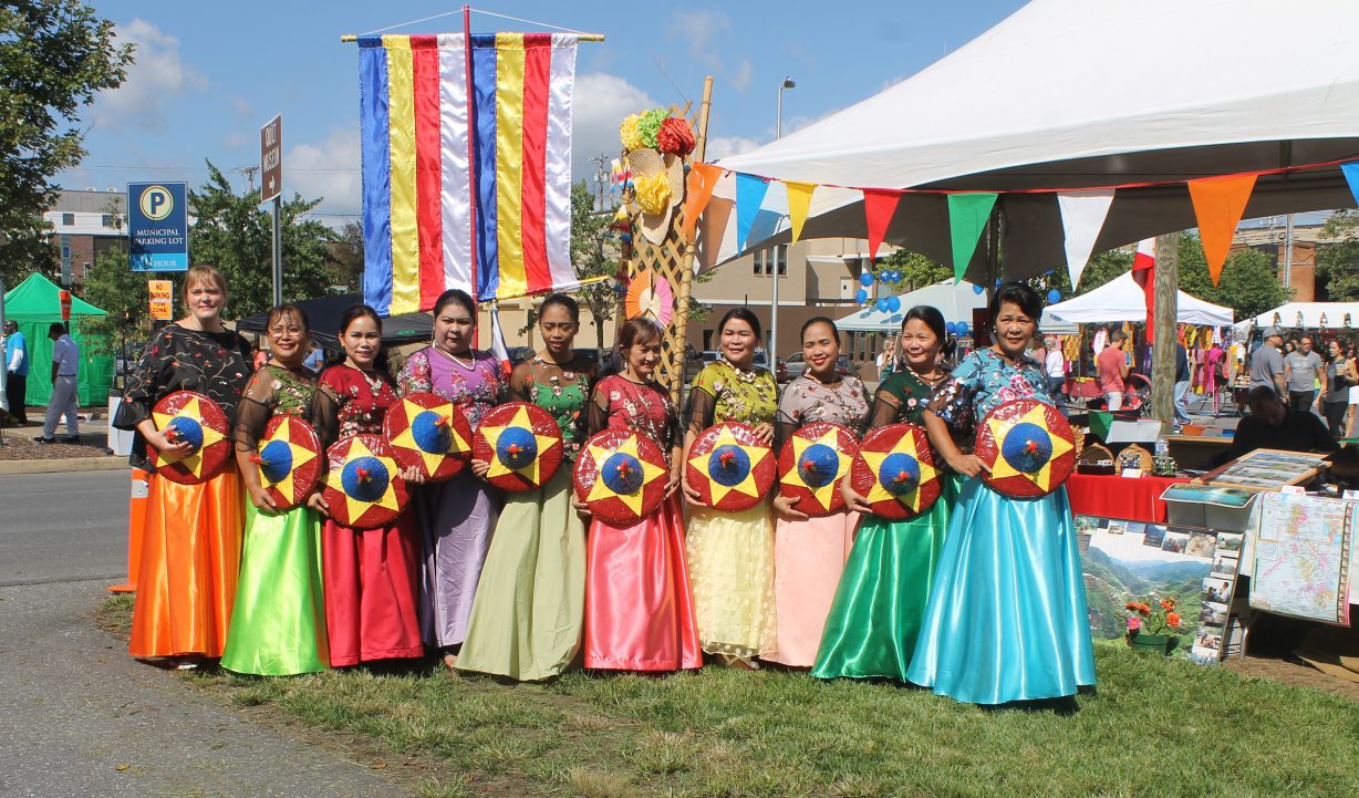 People in colorful dresses stand together