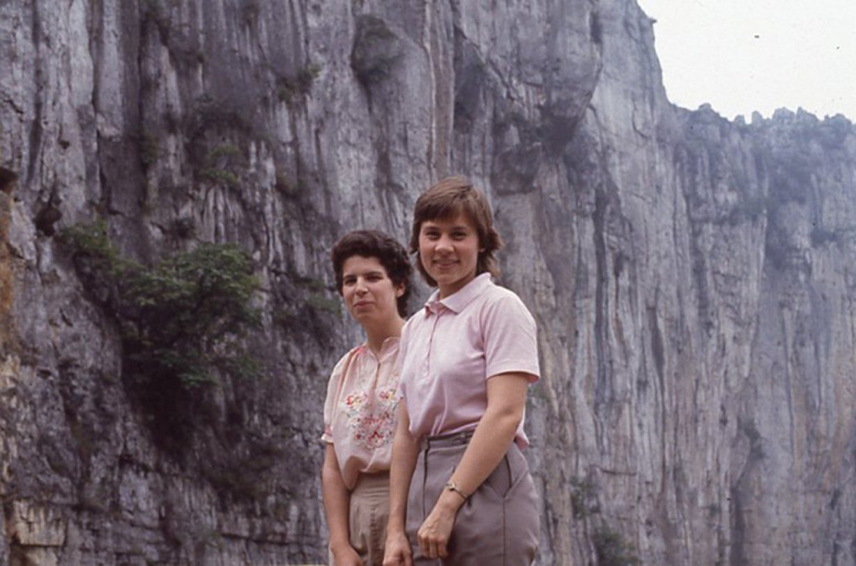 Two women standing in front of a cliff
