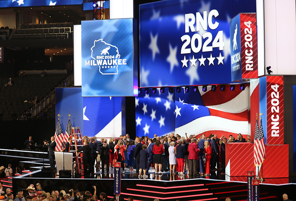 a stage with digital screens showing red white and blue designs and "RNC 2024"