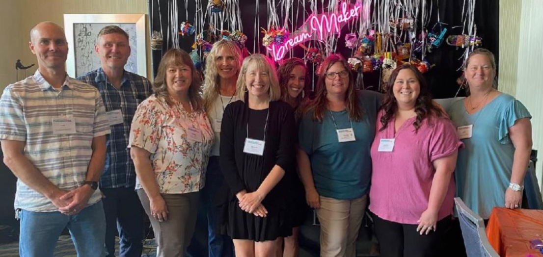 people with name tags pose for a photo