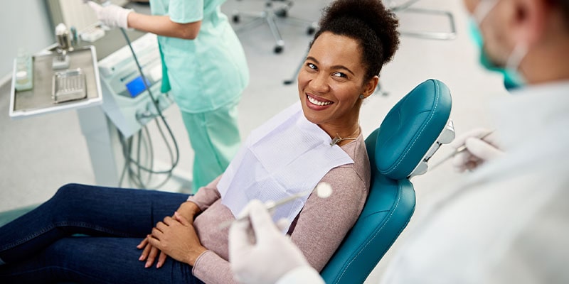 A patient in care is comfortable sitting in the dental office chair because of the dental office cleanliness