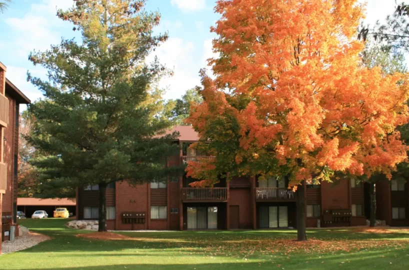 Exterior with fall foliage of furnished apartment building in Wyoming, MI.