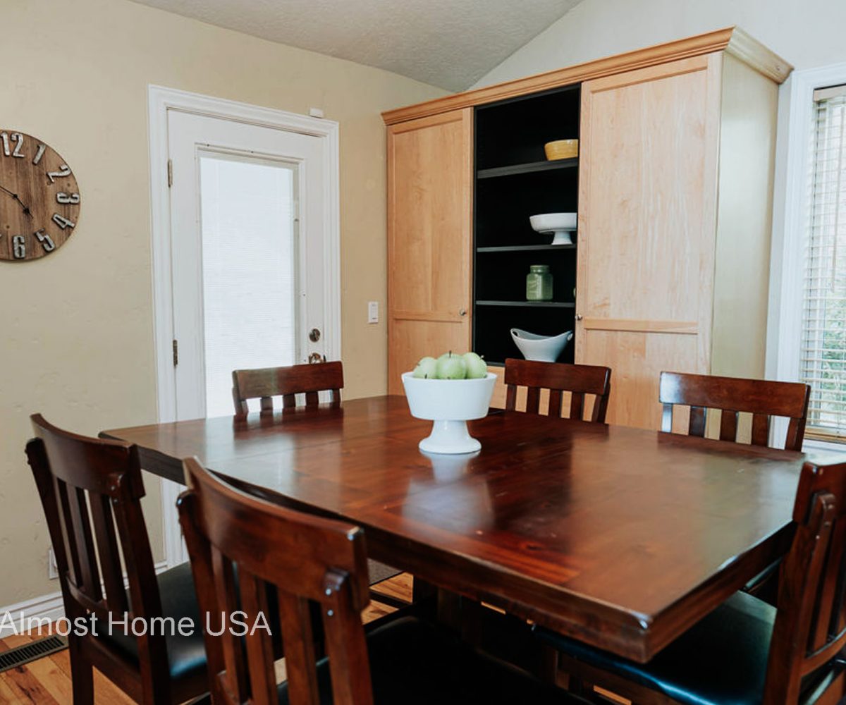 Large cherry dining table in furnished home located in Sandy, Utah.