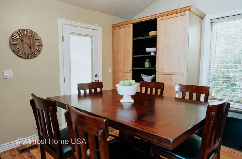 Large cherry dining table in furnished home located in Sandy, Utah.