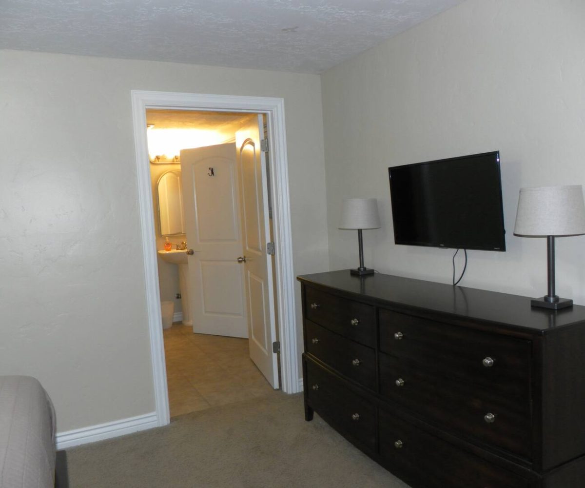 Smart TV in master bedroom in furnished home located in Sandy Utah.