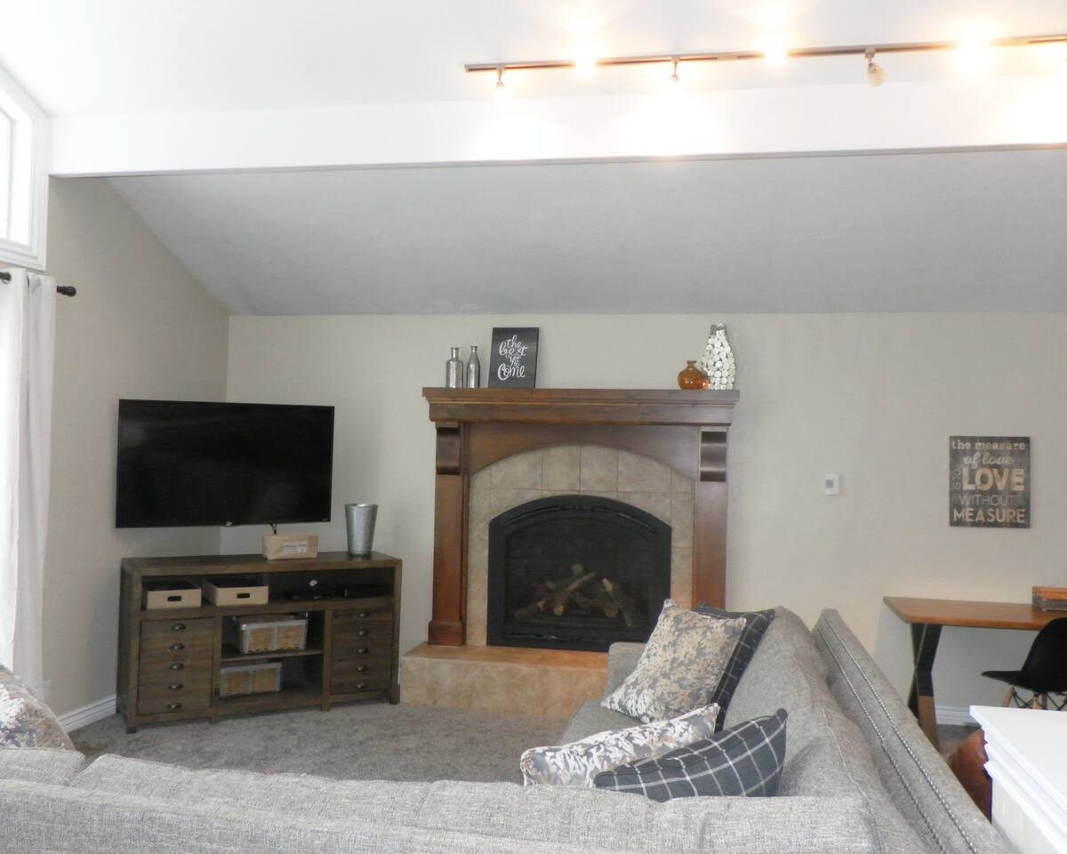 Gas fireplace in living room in furnished home located in Sandy Utah.