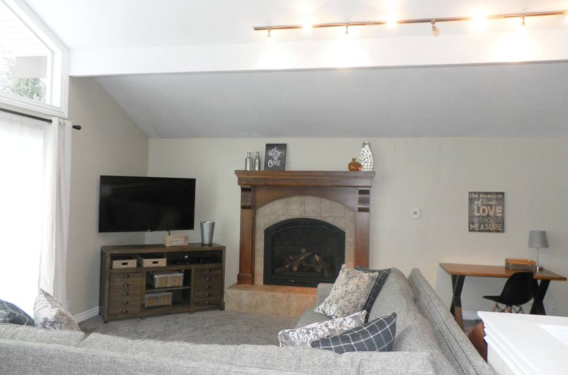 Gas fireplace in living room in furnished home located in Sandy Utah.