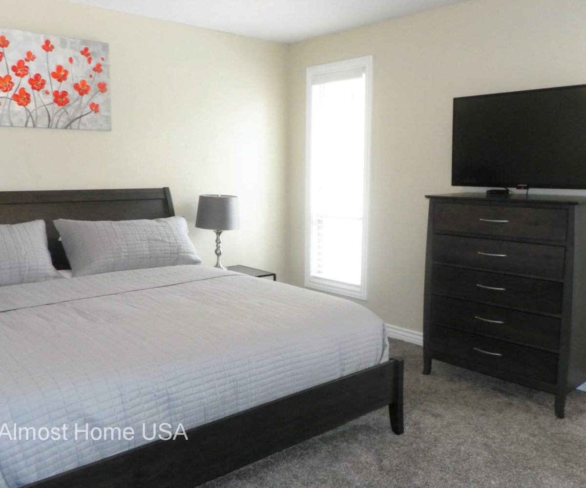 King bed in furnished master bedroom located in furnished home in Sandy Utah.