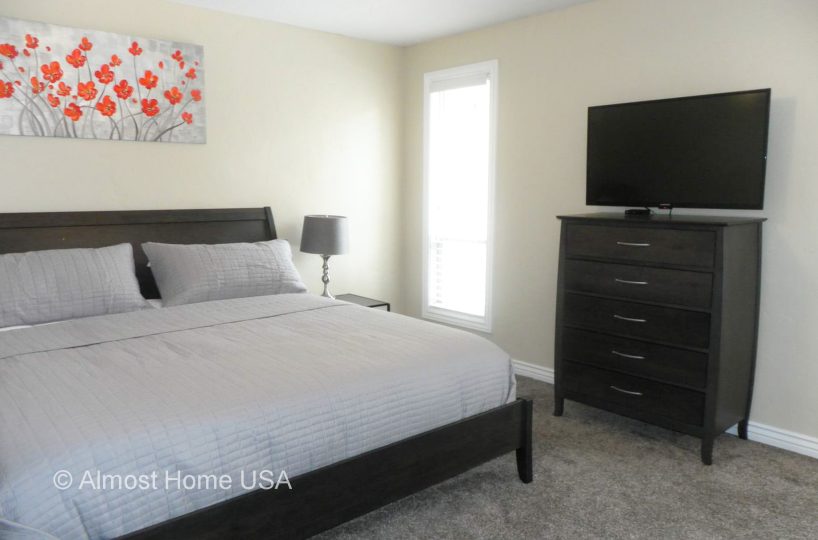 King bed in furnished master bedroom located in furnished home in Sandy Utah.