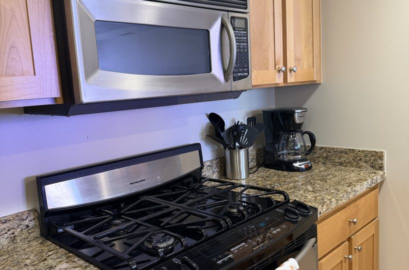 Fully equipped kitchen in furnished condo in Salt Lake City.