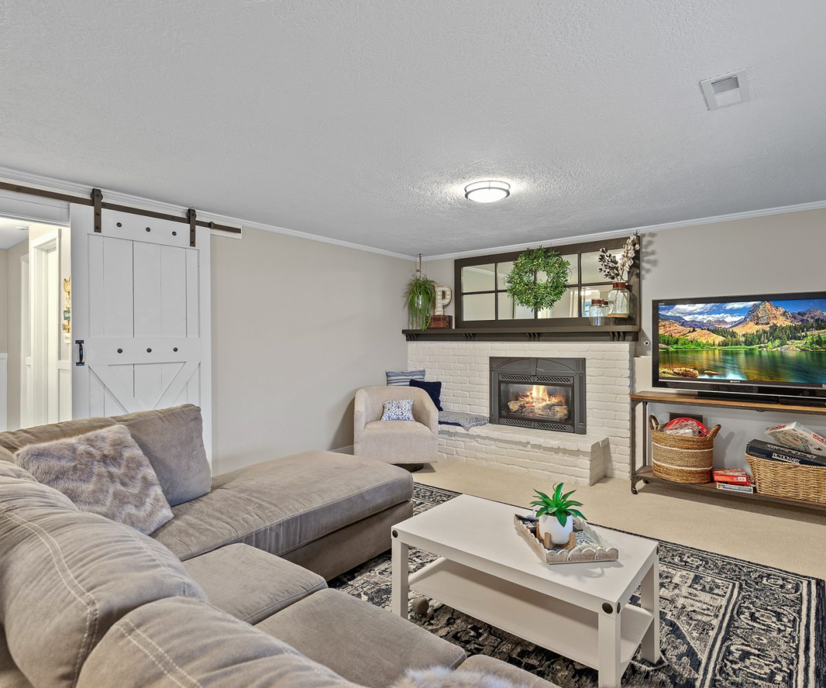 Family room with fireplace in furnished home located in Liberty Lake, WA.