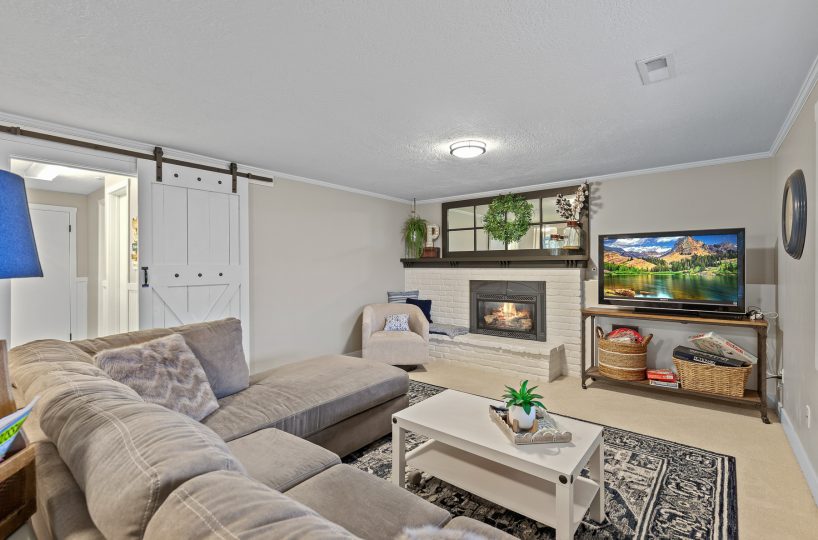 Family room with fireplace in furnished home located in Liberty Lake, WA.