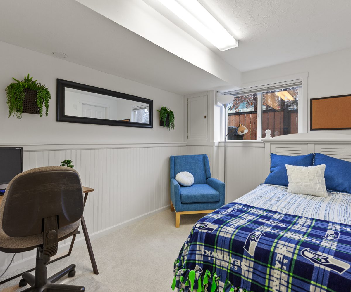 Bed and chair in furnished home located in Liberty Lake, WA.