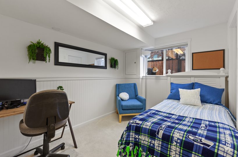 Bed and chair in furnished home located in Liberty Lake, WA.