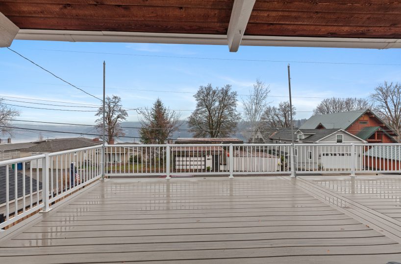 Deck attached to furnished home in Liberty Lake, WA with water views.
