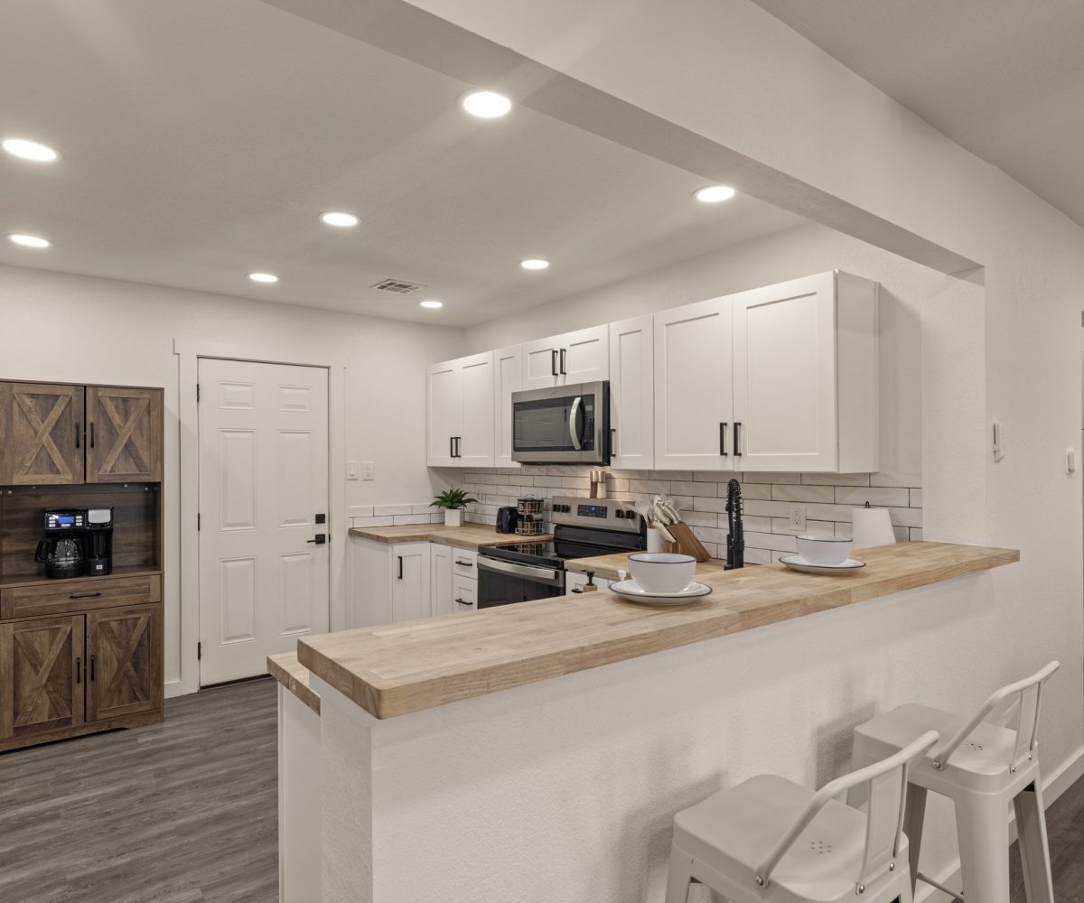 Fully equipped kitchen in furnished home located in Tulsa, OK.