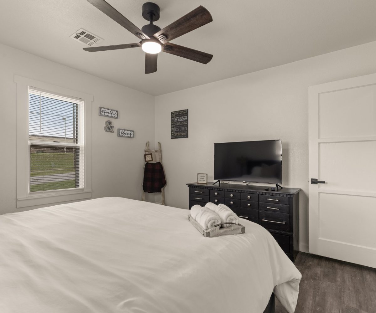 Smart Tv in furnished master bedroom.