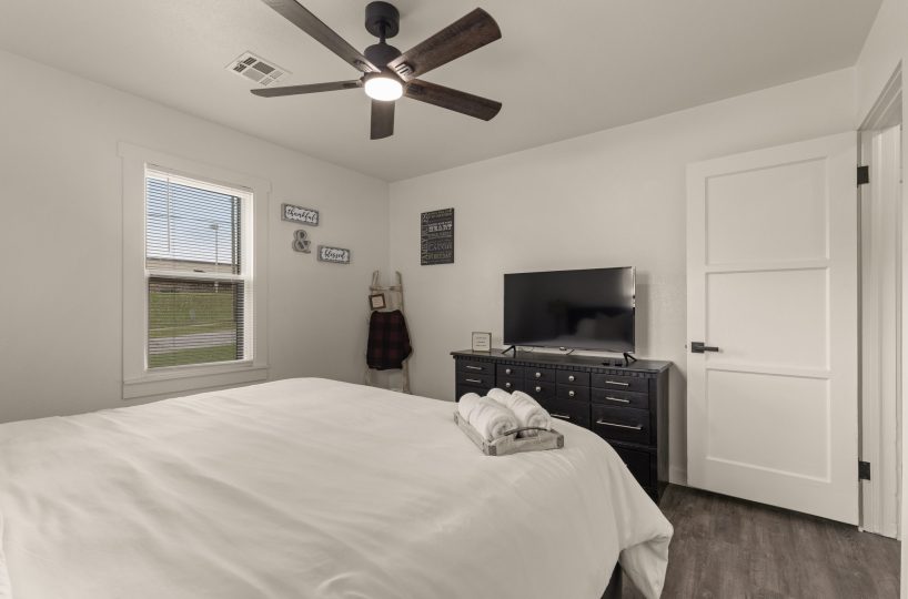 Smart Tv in furnished master bedroom.