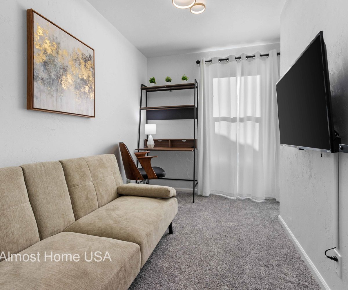 Couch and Smart TV in third bedroom in furnished rental located in Sturgeon Bay, WI.