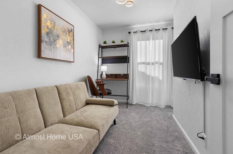 Couch and Smart TV in third bedroom in furnished rental located in Sturgeon Bay, WI.